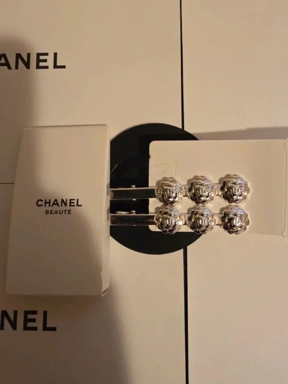 CHANEL SILVER CAMELLIA HAIR CLIPS.